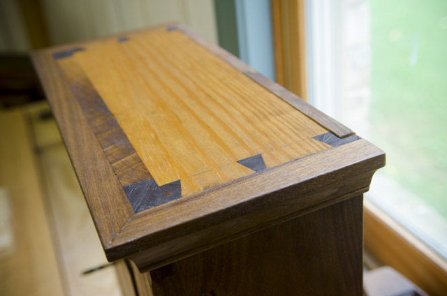A top view of dovetails on a walnut cupboard in the Wood and Shop Traditional Woodworking School