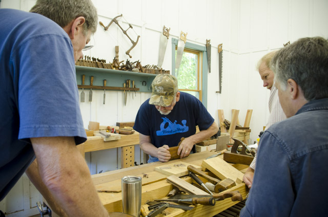 David Ray Pine teaching woodworking class students how to make moldings with a molding plane