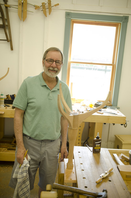 a male woodworking student fitting his sliding dovetail table legs to the spindle at his workbench at Joshua Farnsworth's Wood And Shop Traditional Woodworking School