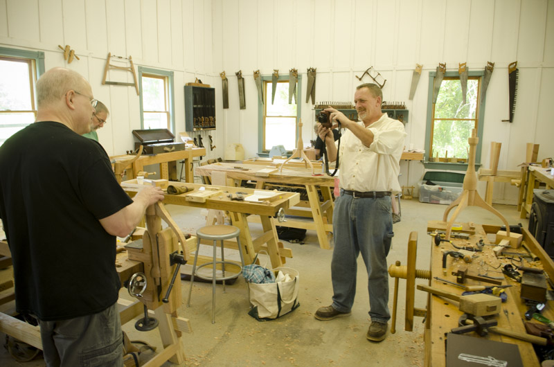 Will Myers taking a picture of a woodworking student at Joshua Farnsworth's Wood And Shop Traditional Woodworking School
