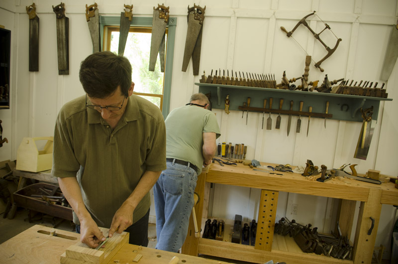a woodworking student using a chisel at Joshua Farnsworth's Wood And Shop Woodworking School