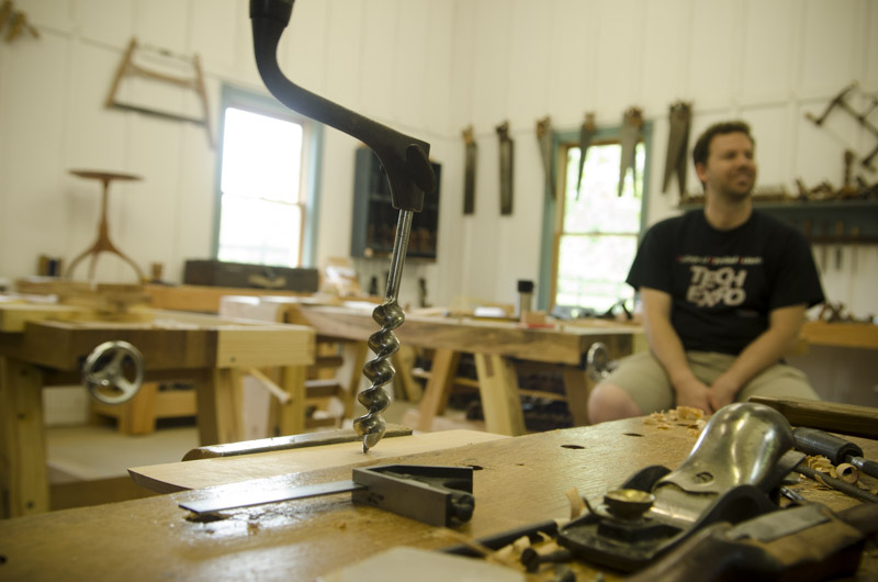 A brace and bit boring a hole at Joshua Farnsworth's Wood And Shop Woodworking School