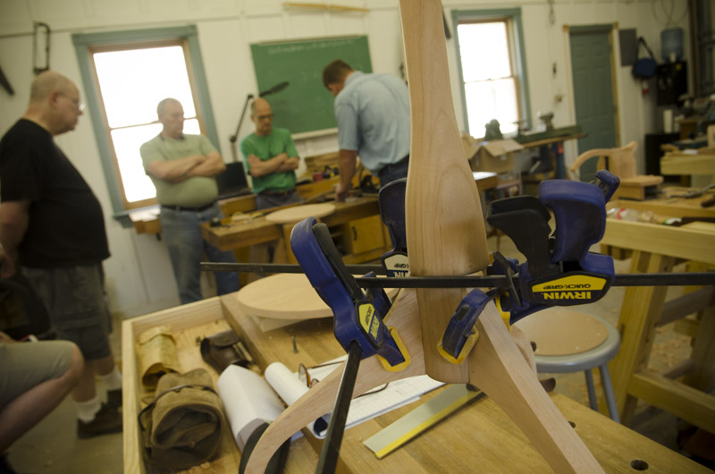 a sliding dovetail table leg being glued up with three clamps at Joshua Farnsworth's Wood And Shop Woodworking School