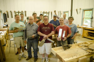 A group of woodworking student displaying their newly finished dovetail saws at Joshua Farnsworth's Wood And Shop Traditional Woodworking School