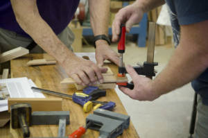 Woodworking students gluing up a wooden try square