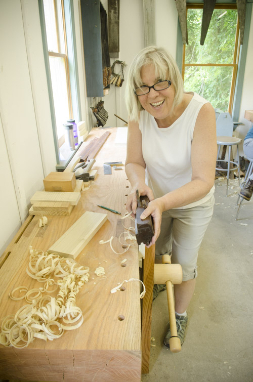 female woodworking student using a tongue and groove come and go plane at Joshua Farnsworth's Wood And Shop Woodworking School