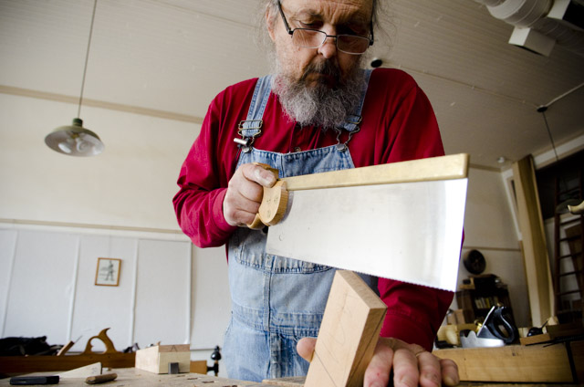 Bill Anderson using a tenon saw while making a wooden bench plane at Roy Underhill's Woodwright's School