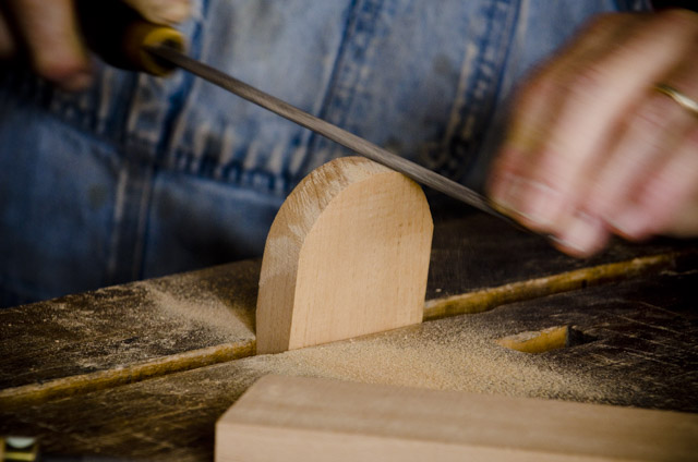 Bill Anderson using a rasp to smooth a handplane wedge while making a wooden bench plane