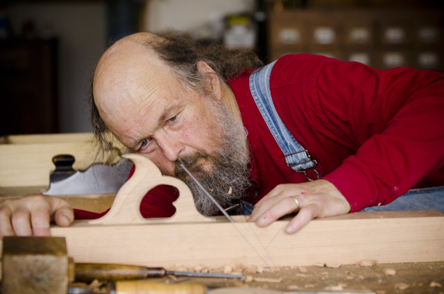 Bill Anderson inspecting the wooden bench plane that he's making