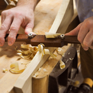 Tom Calisto using a wooden spokeshave that he makes in a woodworking class